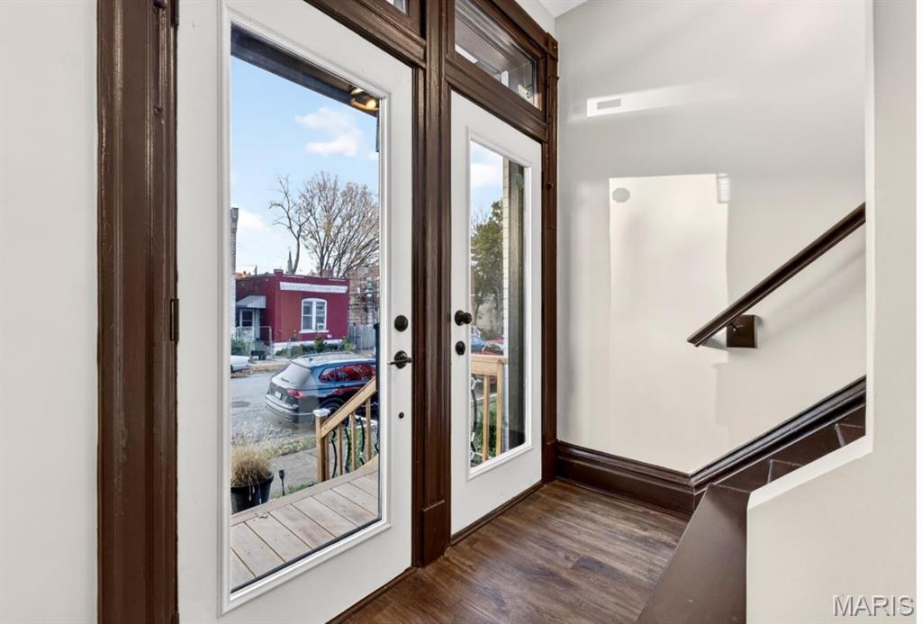 Doorway with wood finished floors and stairs