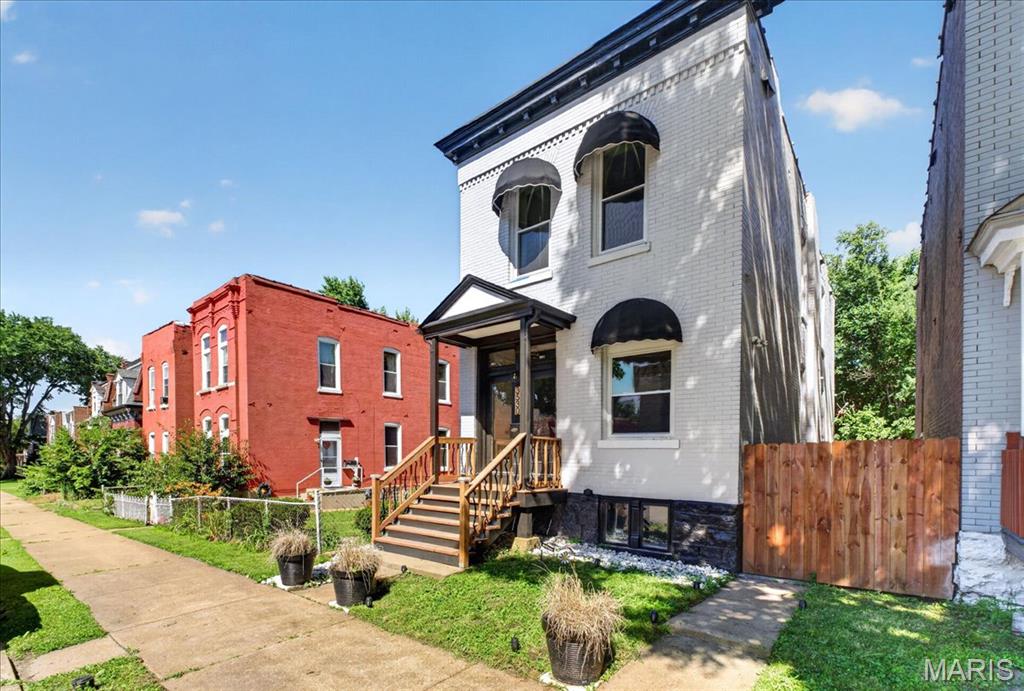 View of front of house with brick siding