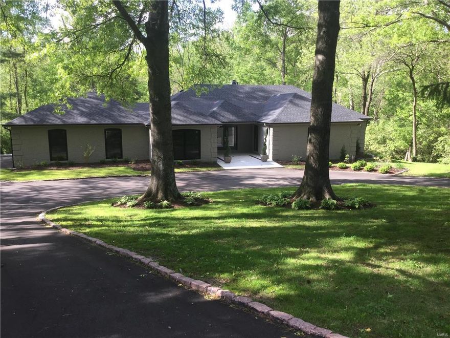 Stunning renovation on 2.6+ private acres, backs to Westwood C.C.  Vaulted foyer w/ custom marble & wood flr., luxurious powder rm., soaring 13' ceiling in LR w/ beams, WB frplc. over looks back yard & new, custom, free-form, radius deck (46' x 12'). Formal DR w/ panel molding, Swarovski crystal chandelier & dbl. sliders that open to deck. Gourmet kitchen w/ Carrara marble tops, high-end appliances, Thermador, 6-burner Pro-Gas Range, 10' island w/seating PLUS a new add'n FR + work area w/ vaulted ceiling. Den w/ Pecky Cypress paneling & dbl.sliding doors that open to deck. 1st floor master w/ walk-in closet & spa-like his & her baths with dual head walk-in shower w/ mosaic tile + Robern med. cabs & Kalista fixtures.  2 add'l bdrms w/ Jack-n-Jill bath w/ quartz counter top! Finished, walk-out LL w/ full bar w/ DW & Sink, Full bath + bdrm. + storage.  QUALITY renovation + addition!  New windows, new electric & plumbing, new roof & gutters, new kitchen & baths, like a new house!