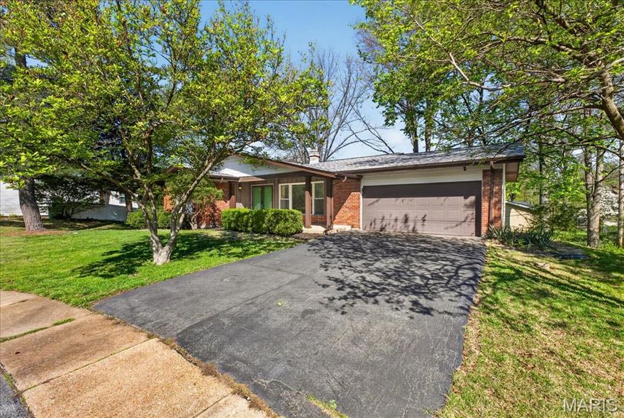 Tucked away at the end of a quiet cul-de-sac, this exceptionally well maintained 3 bed, 2 bath ranch with an oversized two car garage offers a clean, comfortable layout with natural light and beautifully refinished hardwood floors throughout the main living spaces. The open living and dining area flows easily into a bright kitchen featuring ample cabinetry, a wall oven and microwave combo, gas cooktop with stainless hood, and pantry, all opening into a cozy family room with a woodburning fireplace and built-in shelving. From there, walk out to a large deck overlooking a private backyard surrounded by a diverse collection of mature trees that create a peaceful, park-like setting. The primary bedroom includes double closets and a private full bath, with two additional bedrooms and a second full bath on the main level. The lower level is unfinished but pristine, with a rough in for a future bathroom and a walkout to the patio, offering flexibility for storage, a home gym, or future finish. Move in ready and exceptionally maintained, this is a home that offers both comfort and long term value in a highly convenient location near Creve Coeur and Maryland Heights.