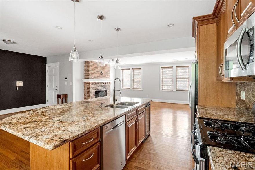 Live in the cultural center of St. Louis in this immaculate, 2-bedroom (could easily convert back to 3bd), 2-full-bath, 3rd-floor walk-up condo in the heart of the West End. With a lovely private outdoor patio, in-unit laundry, and gated, secured garage parking for 2, this stands alone. The kitchen boasts an enormous island, granite countertops, custom cabinets, stainless-steel appliances, and a custom wine fridge. The kitchen is completely open to the dining area, and the incredible living room has a gas fireplace with a TV hookup, exposed brick, and loads of windows with unobstructed views and natural sunlight. The primary suite is a sanctuary, with dual vanity sinks, an oversized shower, and a large, organized walk-in closet. The current dedicated office is generous and ready for your hobby or career, formerly the 3rd bedroom. Beautiful hardwood floors, recessed lighting, energy-efficient windows, and quality HVAC. Minutes from Barnes/Jewish Hospital and the Cortex. Location: End Unit, Upper Level.