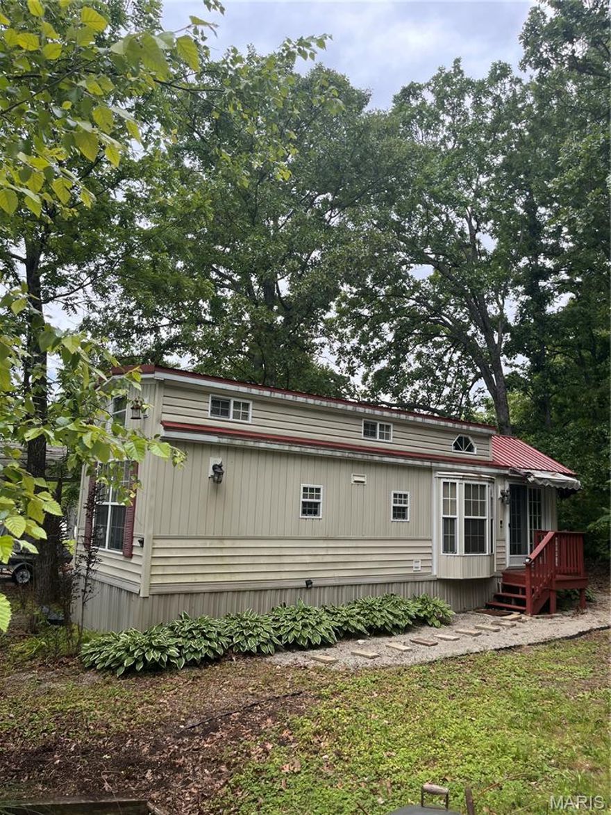 Enjoy affordable lake community living in Goose Creek Lake! This charming tiny home offers the perfect weekend getaway or low-maintenance retreat with access to boating, fishing, swimming, and all the amenities the community has to offer. Situated on a level lot with covered parking and additional storage, this property is move-in ready and ideal for relaxing summer weekends or year-round enjoyment. conveniently located near community recreation areas, pool, beach access, and boat ramp. All furnishings are included in the sale, making this a truly turn-key opportunity. The neighboring twin property is also available for purchase, offering a unique opportunity for additional space, expanded use, or potential investment property used as a rental property. the possibilities are endless!!