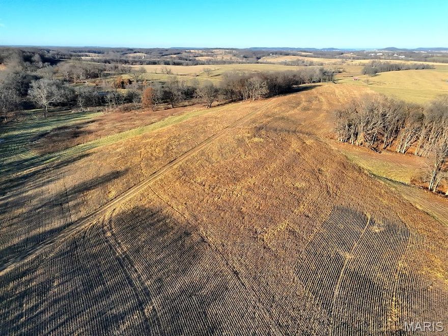 77.2- Acres – SUPER nice combo farm is a superior location. This recreational tract offers the perfect balance of natural beauty, privacy, and convenience. Underground utilities, including electric and county water, are available and ready for your dream home or rural getaway. The property features rolling terrain, mature hardwoods, and gorgeous long-range views, creating the ideal setting for a private estate, family homestead, or recreational retreat.  There are 41 acres of open ground—providing food plots for wildlife and opportunity for income. For the outdoorsman, this is a true hunter’s haven—with an abundance of big deer and turkey roaming throughout the property and surrounding parcels. Whether you’re looking to build your forever home, create a multi-generational family retreat, or enjoy a peaceful hunting escape, this acreage delivers unmatched potential and natural beauty....and there is additional acreage available to expand your country paradise. Deer photos are from the 435+/- acre parent tract and may or may not have been taken on this parcel. Deed restrictions are set in place to help preserve the land’s beauty and integrity...up to four homes allowed (each a minimum of 1,200 sq. ft.), no subdividing, no mobile or modular homes, no hog confinements, no junkyards, no ATV/racetracks, no VRBA/Airbnb, ensuring the landscape remains pristine.