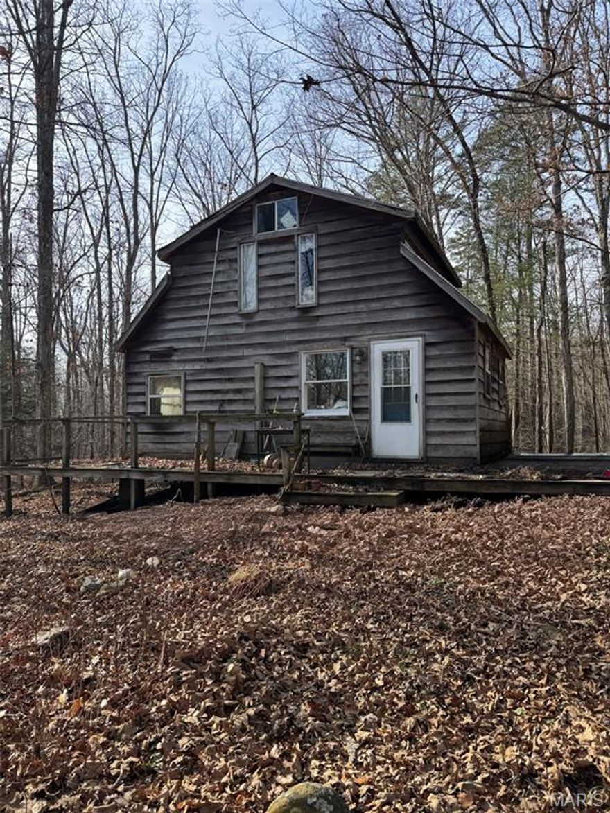10 wooded acres with a cabin located just outside of Marquand.