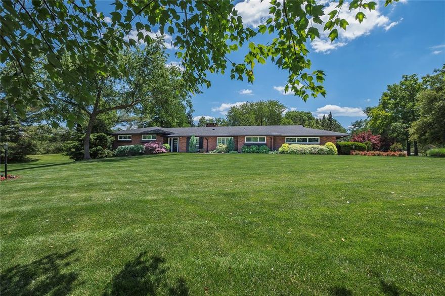 What a phenomenal house and property to call home! Enter from covered porch into 12x8 entry with double coat closet for you and guests. Head into open floor plan with beautiful terrazzo flooring, wood floors or tile, no carpeting! Spacious 24x14 living room has floor to ceiling brick gas fireplace as a focal point. Adjoining is the 14x12 Dining room and open to incredible 28x14 kitchen that is the centerpiece of the open floor plan. Eleven foot island, commercial grade appliances, abundance of gorgeous cabinetry including double panty & coffee bar near the breakfast area. Subzero fridge is included. Vaulted sun room is on the back side of fireplace & overlooking beautiful back patio and luxurious grounds. Bedroom wing has primary suite with his & her closets, upscale bath with stand alone tub, double bowl granite top vanity & large walk-in shower with twin rain heads etc.. Through the triple sliding door is 10x9 balcony overlooking pool & rear grounds. Two other generous bedrooms & hall bath round out this wing. Opposite wing off kitchen has bedroom currently used as office but could be a great guest quarters with remodeled bathroom right off the hallway. Main floor laundry nearby also remodeled including custom cabinetry. Garage is oversize & has separate storage large enough for golf cart too. Lower level has huge recreation room plus a couple storage areas. 1+ acre grounds has the totally refurbished HEATED POOL & adjoining decking/landscaping. Come see starting 5/30!