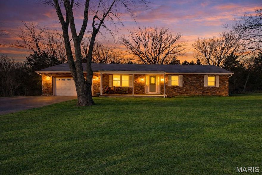 This inviting 3-bedroom, 2-bath ranch sits on 2 peaceful acres, offering a thoughtful blend of character, comfort, and functionality. Perfectly positioned to enjoy the best of Farmington and Park Hills while embracing the serenity of rural living, this home feels both private and convenient. Outdoors, a fully fenced backyard and expansive covered deck create a secluded retreat ideal for quiet evenings or effortless entertaining. Inside, natural light fills the living room, enhancing its warm and timeless appeal. A well-appointed laundry and mudroom seamlessly connects the two-car garage to the kitchen and dining area, adding ease to everyday living. Designed for comfort and connection, this home delivers an atmosphere of warmth, style, and charm.