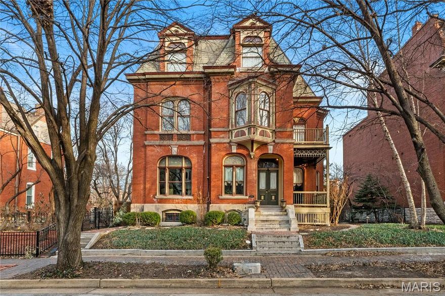 Built in 1884 for Civil War Major Leo Rassieur, this Victorian Manse in the heart of Lafayette Square blends historic character with modern comfort. The property includes the main residence, a two-story carriage house, and a garage, all set on beautifully landscaped grounds. The gracious living room overlooks the tree-lined street and showcases a large stained-glass window and one of many original tiled fireplaces. Hardwood floors, intricate millwork, pocket doors, and multiple fireplaces continue throughout. Formal living, parlor, and dining rooms offer effortless flow for entertaining. The chef’s kitchen features high-end appliances, generous cabinetry, a center island, a breakfast area, and a butler’s pantry with an adjacent powder room and bar. The primary suite includes abundant closets, a bath with heated floors, and a soaking tub beneath a bay window. Upstairs are three additional bedrooms, including one en-suite, plus a third-level bedroom, bath, and office. Second-floor laundry, a two-car garage, and a carriage house with an apartment and gym complete this property. Just steps from Lafayette Square Park and its vibrant dining scene. Lafayette Square Pool membership included (current waitlist approx. 5 years).