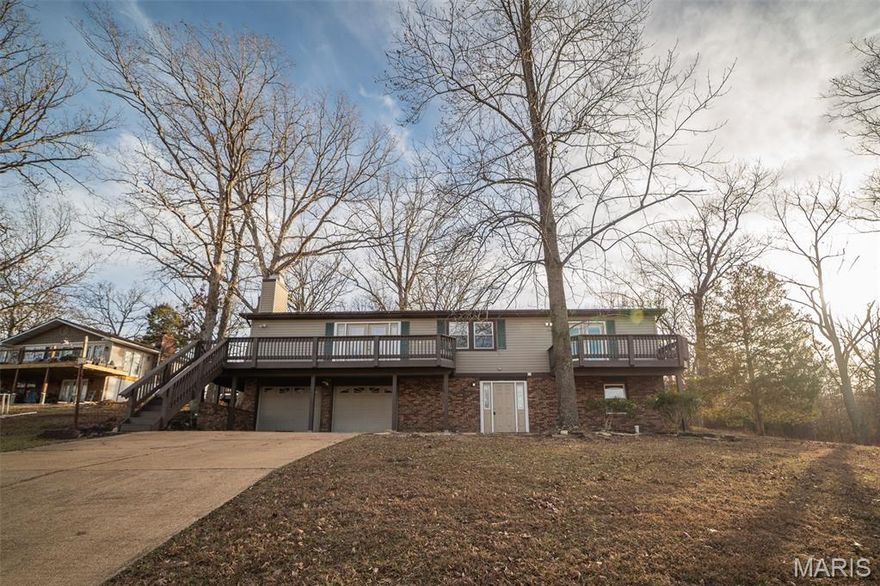 Back on market! No fault of seller! Buyer failed to perform! Beautifully refreshed 3 bed, 3 bath ranch with 2,425 sq ft of finished living space and a 2-car tuck-under garage. This spacious lake retreat features fresh paint, new flooring, and tasteful updates throughout. The large front deck offers stunning lake views—perfect for morning coffee or evening relaxation—while the covered rear porch provides a peaceful, shaded escape. The open floor plan and ample living space make this home ideal for entertaining or quiet weekends away. Whether you're looking for a full-time residence or a weekend getaway, this home delivers comfort, style, and unbeatable views.