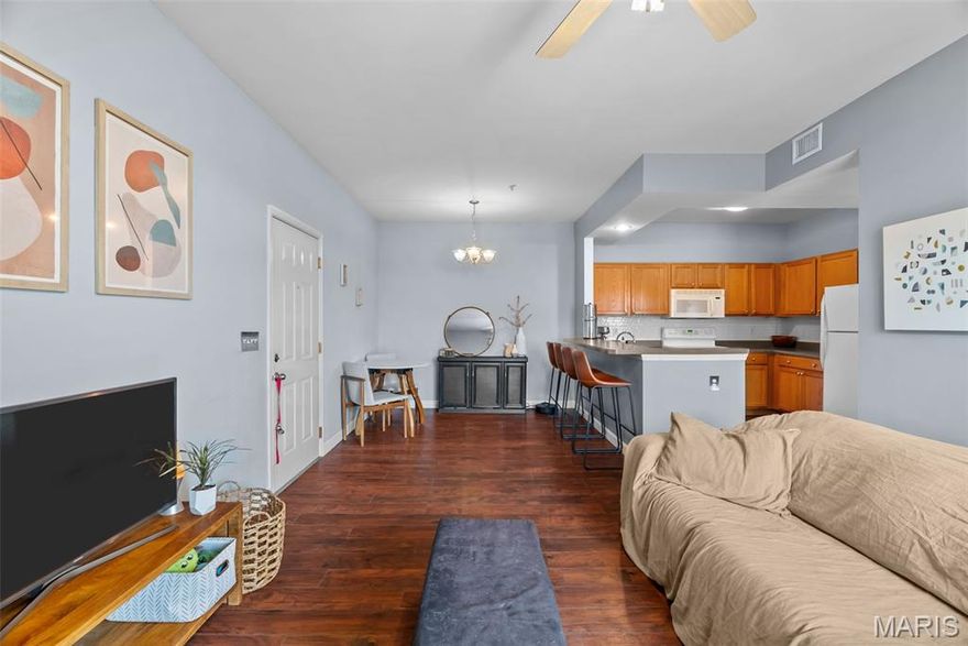 Enjoy the ease of entry level condo living in this bright and spacious unit in Mehlville, nestled at the top of a no-outlet hill, and surrounded by the sounds of nature. Wake up to birdsong and enjoy a cup of coffee on the balcony. The curb appeal is inviting, with brick and stone accents, plus you'll have an assigned covered parking space just outside at ground level. The open layout of the main living area is filled with natural light! The living room flows into the dining room, perfect for entertaining. The kitchen features a breakfast nook, breakfast bar and new backsplash. 9-foot ceilings add to the spacious feel & gleaming laminate floors throughout create a cohesive look. The primary bedroom has a walk-in closet & bathroom w/step-in shower. Another bedroom, full bath w/double sink vanity & tile-surround tub, as well as renovated laundry room complete the space. Just moments from shopping, restaurants, parks, Grant's Trail, schools, and quick access to I-55 and 270. Fantastic opportunity!