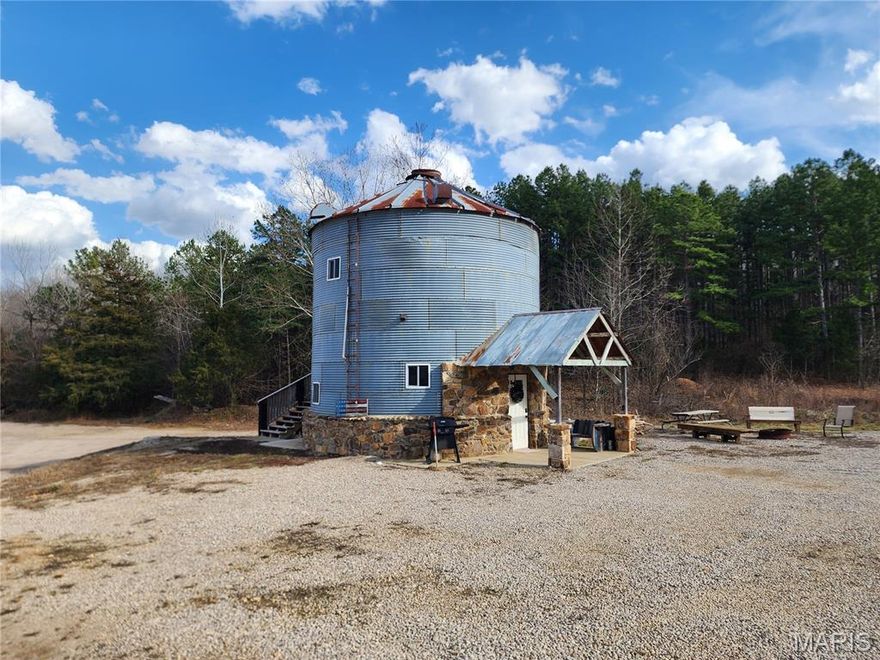 This is a very unique property.  An old grain bin has been masterfully transformed into a home.  With 1300+ square feet of living space offering 2 bedrooms, 2 full baths, a chef's kitchen with granite countertops, curved stairway and 3 levels and a covered balcony overlooking the beautiful countryside, this is a "must see".  The home has been utilized as a successful, nightly rental with sleeping for 7-8 and owners can provide income statistics.  Here is the cherry on top, this tastefully decorated home comes fully furnished and ready to produce income or ready to move into.  Sitting on 20 M/L acres just on the outskirts of Piedmont, MO and close to Sam A. Baker state park, the St Francis & Black rivers. Clearwater & Wappapello lakes and thousands of acres of National forest the potential for this property is endless.  The acreage lays very nice with multiple building spots.  This would be an ideal place to build a new home and keep receiving the income from the "Grain bin" rental.  Another option would be to build cabins or tiny homes on the acreage.  There is a great place to build a small lake.  The possibilities go on & on.  Schedule your appointment for a personal viewing today.