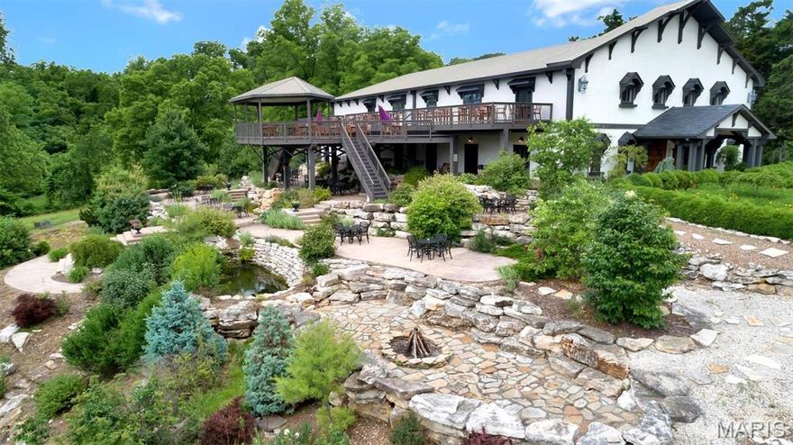 Fantastic business/lifestyle opportunity! Ripe with potential for a new caretaker. The charm and grandeur of this property offer a canvas for conferences, retreats, weddings/receptions or other hospitality events. As you enter the hall through the large custom wood doors and walk thru the main floor, notice the exceptional woodwork and stained glass. The large stone fireplace at one end fills the hall with warmth. A second level mezzanine offers a second bar and additional seating. Six sets of east facing french doors lead to multiple levels of outdoor entertainment spaces overlooking the MS. River Valley. Set on 14+ acres of walking gardens, quaint paths and water features. An outdoor pizza kitchen is in addition the commercial kitchen attached to the hall. In addition to the hall, the property includes a 4 bed house with spectacular views of the valley and an "overlook" With an alter/stage for outdoor weddings or music. The possibilities are endless! Your vision can become reality!