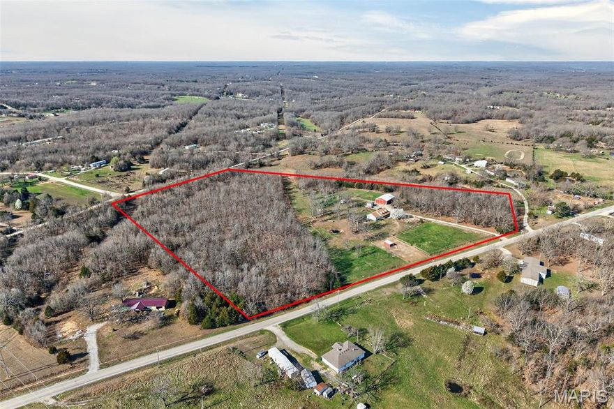 Great 24-acre hobby farm on Hwy WW in Lebanon with blacktop access to a gated entrance! This mini farm offers a great mix of open pasture and woods, making it ideal for livestock, horses, or hunting. The property is fully set up with multiple outbuildings, including a 30x60 barn with three 10x20 stalls, tack room, 10x20 lean-to for hay, tons of storage, full electric, and a bathroom (water line from house to barn needs replaced). Also included are a 55-ft corral with river sand footing, 14 fruit trees including apple, peach, pear, and crabapple, two duck coops, an 18-bird chicken coop, and a 3-ton feeder. Fenced and cross-fenced for cattle, goats, and horses. The 3-bedroom, 2-bath home offers approximately 1,800 sq ft with a large kitchen, abundant cabinetry, center island, spacious mud/laundry room with sink, living room with coffered ceilings and gas fireplace, plus a dining/den area. A covered wraparound porch, back deck, and classic dormers complete the package. If you’ve been looking for manageable acreage with easy highway access and everything in place, this one is ready to go.