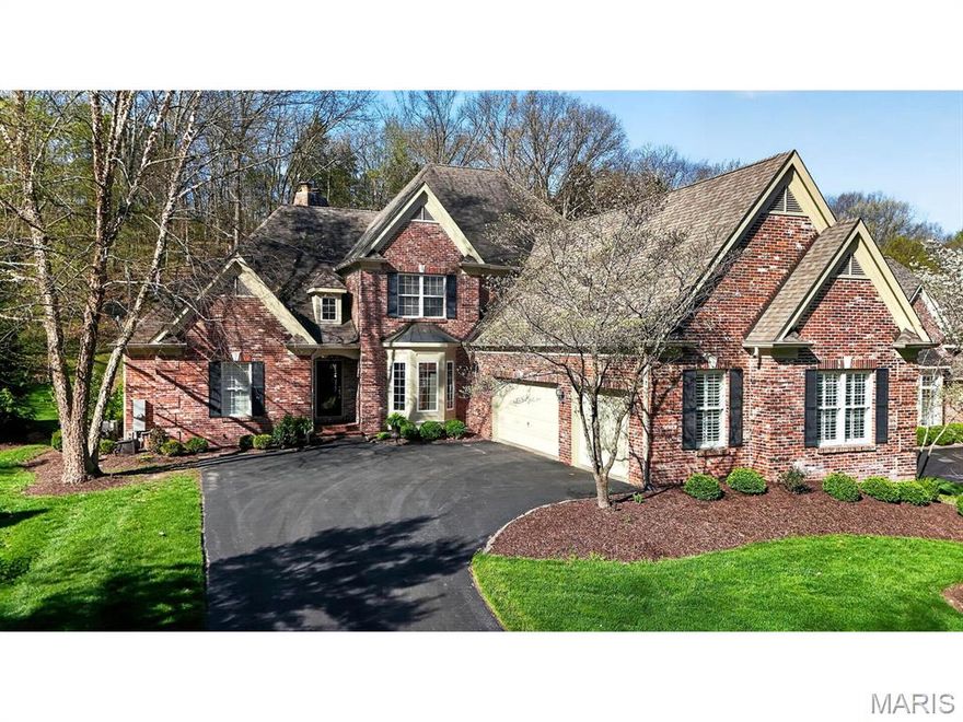 Exquisite 1.5-story residence in the prestigious St. Albans Country Club community, showcasing extensive updates and impeccable attention to every detail. The main level features Brazilian Koa hardwood floors throughout, complemented by a dramatic two-story stacked stone fireplace in the great room and an elegant dining room with inverted cove ceiling, wainscoting, and crown molding. The gourmet kitchen is a chef’s delight with an open-concept renovation, luxury appliances, granite countertops, custom 42” cherry cabinetry, walk-in and butler’s pantries, and expansive counter seating for up to 8, along with 8’ doors, 6” baseboards, extensive millwork, and custom built-ins throughout. The main-level primary suite offers a refined retreat with sitting area, bay window, gas fireplace, plantation shutters, and hardwood flooring, while the spa-inspired bath includes marble-topped vanities, a dressing area, Jacuzzi tub, and oversized custom shower. Three additional en suite bedrooms with walk-in closets (two upper level, one main level) provide exceptional comfort and flexibility. The Upper level also features a beautiful library with wood floors and built in wood cabinets and bookshelves.  The finished lower level is designed for upscale entertaining with a built-in bar featuring honed granite, custom cabinetry, drawer dishwasher, and mini refrigerator, plus a 500-bottle wine cellar, stone fireplace surrounds, game room, workout/theater space, office or sleeping area, full bath, and possible in-law quarters. Outdoor living in the professionally landscaped yard is the true centerpiece.  Lighting on landscaping, deck & flagpole, expanded composite deck, outdoor fireplace, built-in hot tub, and a striking waterfall and pond, all complemented by a stamped concrete patio and multi-tiered layout ideal for entertaining or private relaxation. 3 car garage with electric heating & epoxy floor.   Don’t miss this special home with endless improvements!