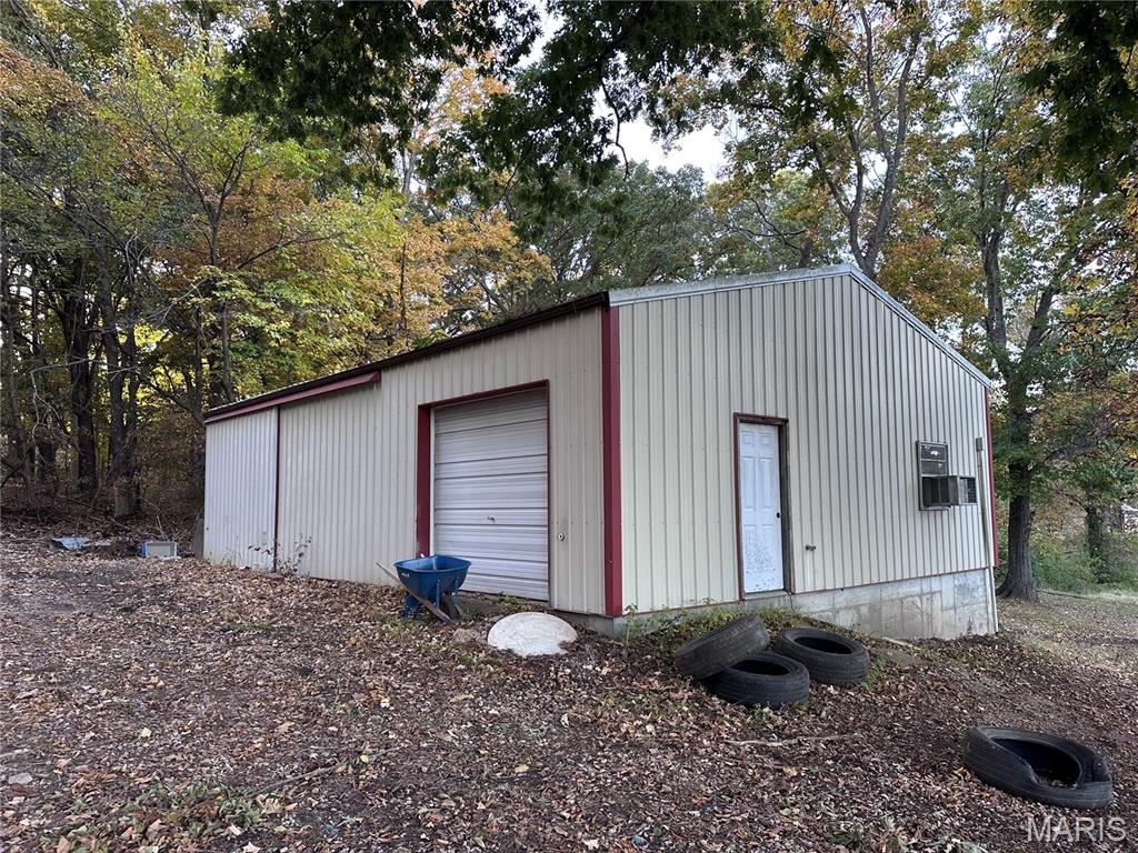 Detached garage with view of scattered trees