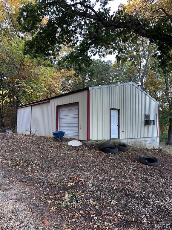 View of outbuilding featuring view of scattered trees