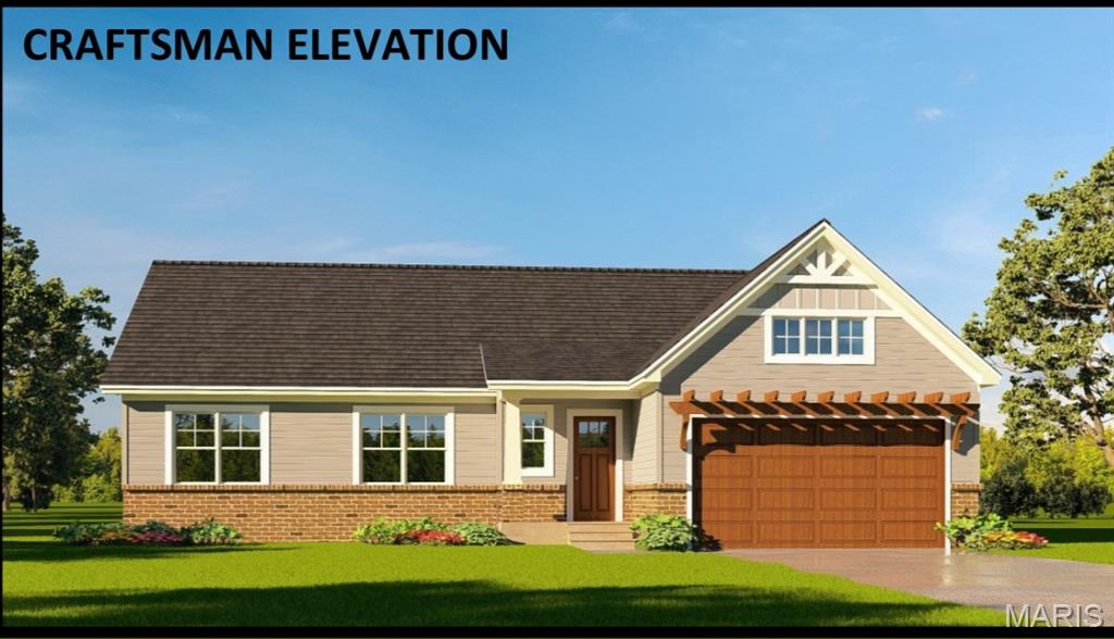View of front facade with a front yard, brick siding, an attached garage, and driveway