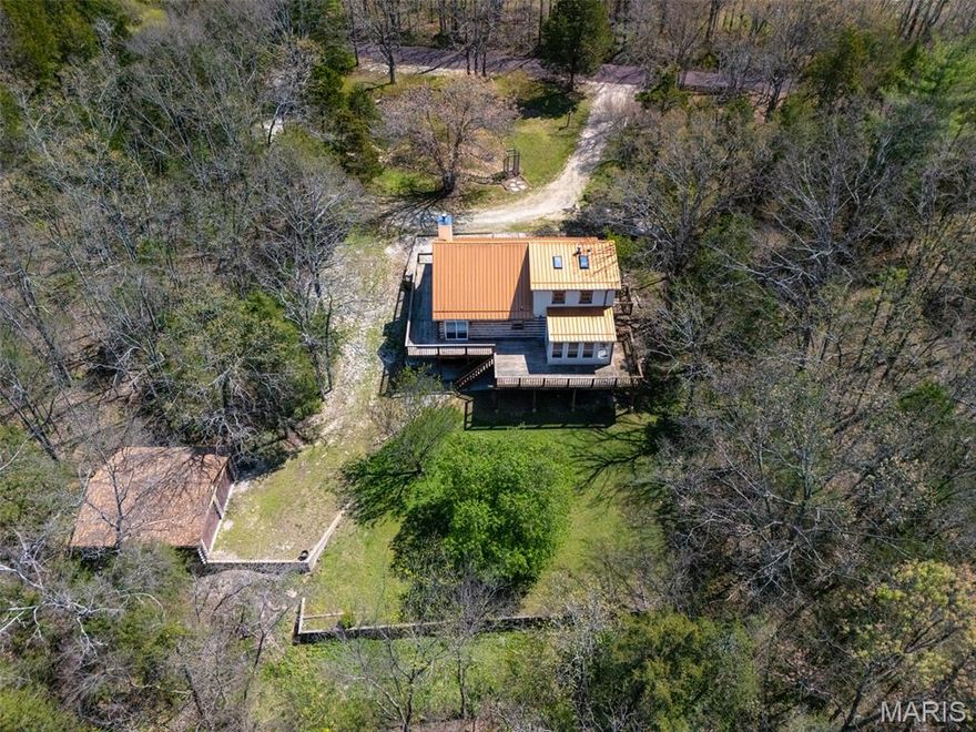 Discover the perfect blend of rustic charm and unmatched privacy with this beautiful log cabin set on 11.90 acres w 4+ car garage(s). Tucked away on a private street with no HOA restrictions, this property offers room to roam, space to expand, and the freedom to create your own retreat. A circle drive welcomes you home and leads to both a 24x24 detached oversized garage and a 24 x 28  tuck-under garage, providing abundant parking, storage, and workshop potential. Wrapped in character, the cabin features a full wrap-around porch offering 360° views of woods, wildlife, and total seclusion. Step inside to soaring wood ceilings, exposed beams, and a stunning stone wood-burning fireplace that anchors the great room. The main-floor primary bedroom includes a spacious bath with a charming claw-foot tub. An enclosed back porch—surrounded by windows overlooking the woods—offers incredible versatility as an office, additional bedroom, or cozy family room. The upper level includes a private bedroom with its own full bath, perfect for guests. The walkout lower level is ready for your finishing touches and offers even more potential living space.
Outdoors, the acreage is a dream:
Small pond with gazebo
Riding and walking trails
3 total lots included
The unique lot configuration opens the door to endless possibilities—build a family compound, keep the land as one expansive property, build on one or both subdivided lots, or sell them later as an investment.
This is more than a home; it’s a lifestyle of privacy, nature, and opportunity.