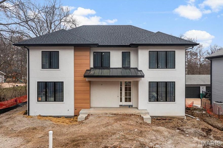 Rare luxury new construction in Webster Groves offering exceptional design, high-end finishes, and nearly half an acre of deep backyard space — an opportunity seldom found in this established community.

The main level showcases beautiful white oak hardwood flooring throughout, a dedicated office, and a spacious open-concept layout designed for modern living. The gourmet kitchen features exquisite custom cabinetry, quartz countertops, large waterfall island, and seamless flow into the living area, creating an ideal setting for entertaining. A main-floor bedroom + accessible full bath provides flexibility for guests or multigenerational living, along with a main-floor laundry + mudroom — one of two thoughtfully placed laundry areas in the home.

Upstairs, you’ll find four generously sized bedrooms including a luxurious primary suite. Equipped with a soaking tub, a spacious spa like shower with a bench and double rain heads, custom white oak vanities with a makeup area between, and a custom walk-in closet. 

As for the other bedrooms, two bedrooms share a Jack-and-Jill bathroom, while another offers its own private ensuite — all featuring custom closet shelving for exceptional organization. A spacious second-floor luxury laundry room adds everyday ease and efficiency.

The finished lower level provides an expansive open rec room complete with a wet bar and beverage cooler, ideal for entertaining or additional living space. A bedroom and full bath offer excellent guest accommodations, while two oversized storage rooms provide incredible flexibility for a home gym, hobby space, or future expansion.
Outside, the property offers a large covered patio, private attached two-car garage, large additional parking pad, and a rare deep backyard providing exceptional outdoor space not often found in newer construction.

Located within the highly sought-after Webster Groves School District and walkable to Avery Elementary, parks, local dining, coffee shops, and retail, this home presents a truly rare opportunity to enjoy luxury new construction in Webster Groves.