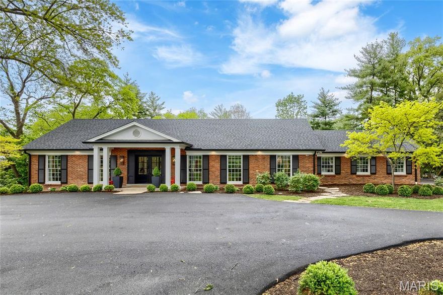 Extensively renovated full brick 1.5 Sty on parklike 1.2-ac grounds. Open floor plan features sophisticated interior detailing & appointments throughout. Impressive porch entrance with architectural pillars & double doors with glass panes leads to coffered foyer with diagonal oak flooring, well-appointed living room with wet bar, elegant dining room & stunning family room highlighted by floor-to-ceiling slate fireplace. Designer kitchen features custom white Shaker cabinetry, quartzite countertops, GE Monogram appliances & 13’ center island. The primary bedroom suite radiates warmth with a linear fireplace & marble bath with freestanding tub & walk-in shower. Hardwood floors continue to the 2nd level with 3 additional bedrooms, 2 with ensuite baths.  Lower Level entertainment space includes recreation room with wet bar & game room plus office, sitting room, workout room & full bath. French doors open to outdoor living area with covered patio & expansive pool surrounded by landscaped gardens.