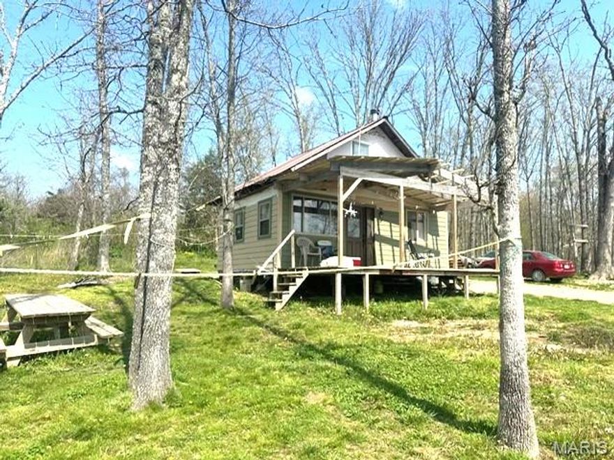 Located in Mtn. View, MO- 4.8 acres m/l on a large 8 acre shared lake with neighbors. Unfinished off grid cabin 16x24 1.5 story, , hand dug well, and some beautiful views.  Cabin has a loft upstairs, full bathroom, kitchen bedroom (no closet) living room on the main floor. NO RESTRICTIONS and sits at the end  of a dead end road. Needs some finish work, but you can live in it, and finish the way you want it. Electric available by having electric company adding two poles (per Seller)