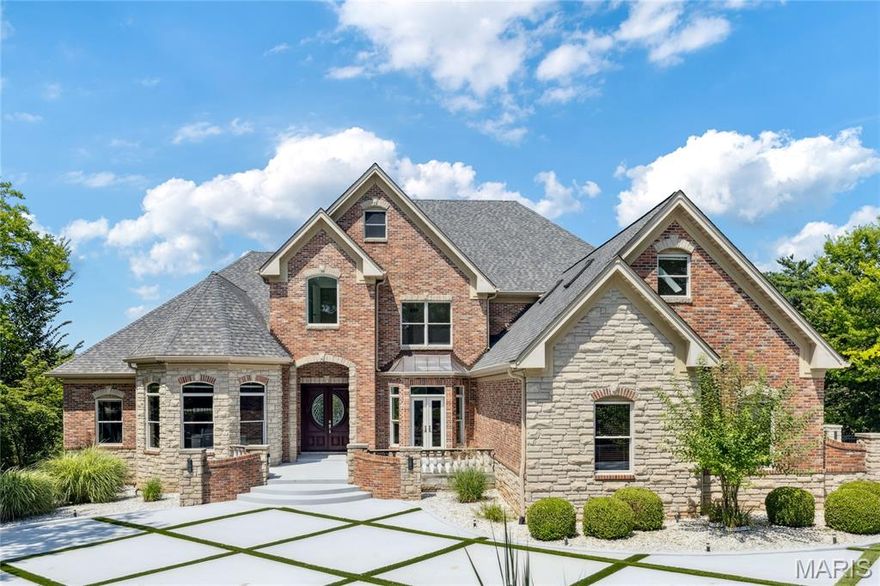 Superior craftsmanship & distinctive design elements define this exquisite 8003 sf brick & stone gated estate home in premier location. Barrel-vaulted foyer leads to library-paneled study, elegant dining room & stunning great room with floor-to-ceiling stone fireplace & soaring windows that overlook parklike backyard. Designer kitchen with 42” white cabinetry, granite countertops, commercial grade appliances & butler’s pantry adjoins light-filled breakfast room, gathering bar & vaulted hearth room with marble fireplace. Primary bedroom suite offers an appealing retreat with linear fireplace, beautifully appointed bath with shower spa & access to private deck. The 2nd floor extends the living quarters with 3 additional ensuite bedrooms & bonus room. Lower Level includes recreation room with see-through fireplace, game room with wet bar & media room plus fitness studio, sauna, 5th & 6th bedrooms & 1 ½ baths. Situated on a 1-acre lot with 2 decks, covered & open patios, pool with spa & pavilion with grilling station.