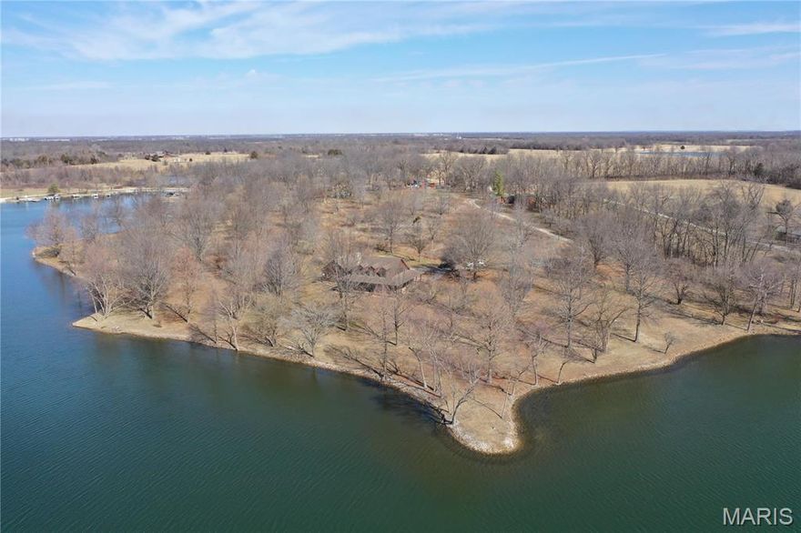 Discover the perfect blend of comfort and country charm in this beautiful two story home nestled on 7.68 acres on pristine lakefront  property overlooking 100+ acre lake.  The home has a spacious primary bedroom and bath on the main level.  The upstairs offers two additional bedrooms and bath.  The home includes a large wrap around porch of enjoying the beautiful sunsets over the lake.