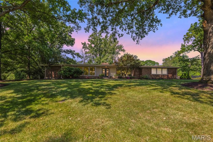 Modern comfort meets timeless charm in this classic mid-century modern sprawling ranch in sought-after Ladue Estates subdivision! Step into a sunlit living and dining space with wide windows that frame the entry and bathe the rooms in natural light. A chef's kitchen awaits - with crisp white cabinetry, granite counters, double ovens, and sleek stainless-steel appliances. Enjoy breakfast at the bar or dine in the casual eat-in area that opens to a screened porch made for relaxing evenings. Head outside to a spacious patio featuring a stone fireplace and hot tub - your own private retreat! Inside, a cozy family room with wood floors, a gas fireplace, and walls of windows overlooking your almost acre private lot. The main level offers four bedrooms and three full bathrooms. The primary suite impresses with custom closets, double sinks, an oversized shower, and makeup vanity. A secluded fourth bedroom or office sits near a full guest bath - perfect for hosting or remote work. Need even more space? The walk-out lower level delivers 2,000+ sq ft of flexible space for hosting with flair. Includes a wet bar (wine cooler, mini fridge, microwave), a fifth bedroom, full bath, and plenty of storage. Ready for the next chapter? This home checks all the boxes! Located in the prestigious Ladue School District with an amazing central location in Creve Coeur.