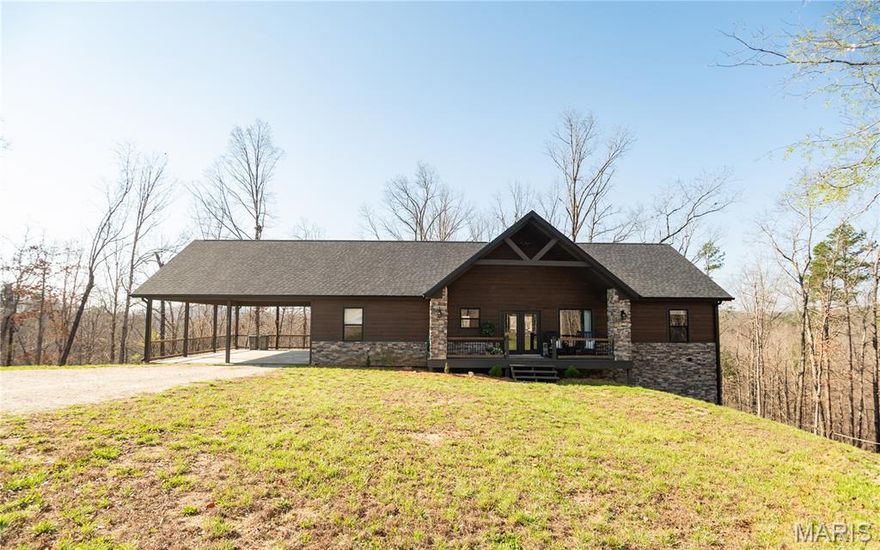 Located just minutes from Big Springs National Park and the beautiful Current River is this splendid 5 bedroom, 3 bath home. Built in 2023 and sitting on 6 +/- wooded acres. This open floor plan design has over 3000 square feet of living space. You will love the oversized primary bedroom and bath with a large custom tile shower and separate jetted tub. The expansive kitchen with a center island, walk in pantry and quartz countertops flow seamlessly into the dining and living room area. The openness is great for entertaining your family and friends. The beautiful windows draw plenty of natural light with a floor to ceiling stonework fireplace it's simply a perfect fit for this home. The lower level has 2 additional bedrooms and a large family room that is perfect for family movie night or maybe your kids need more play space. If you enjoy outdoor lounging the large deck area off of the main level living area is easily accessible, shaded and private. Call for your personal viewing.