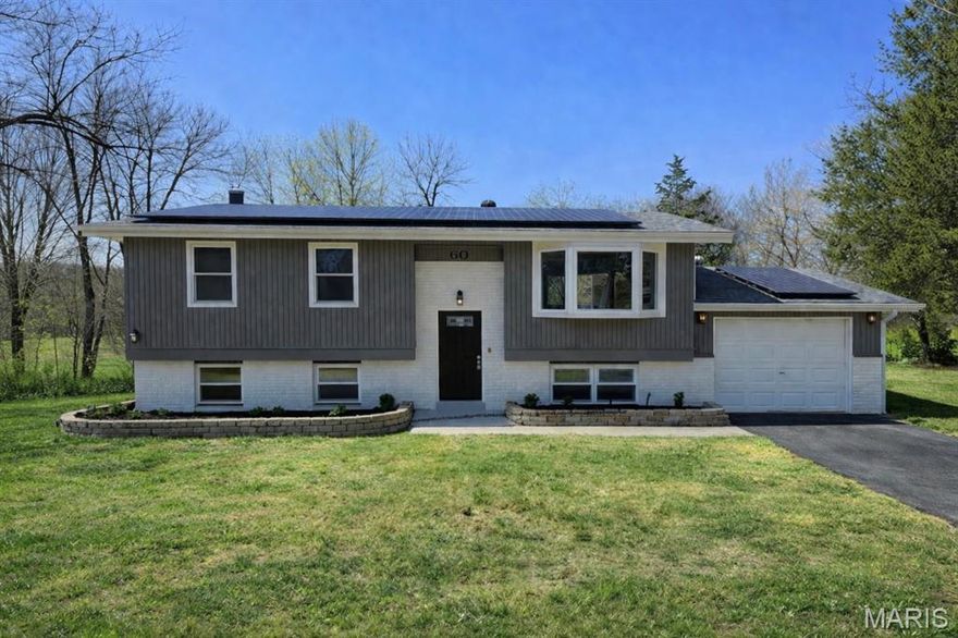 Welcome to this beautifully updated 3 bedroom, 2-bath home offering approximately 1,800 square feet of living space, nestled on a spacious, nearly half-acre lot in the heart of Fenton. Backing to trees the setting feels like your own private oasis while still being just minutes from everything. The updated kitchen is a true standout featuring quartz countertops, a stunning subway tile backsplash, custom soft-close cabinetry, and all new stainless steel appliances. The home also offers updated bathrooms and brand-new carpet, creating a fresh, move-in ready feel throughout. The finished lower level includes a third bedroom, an additional updated full bathroom, and a striking black brick wood-burning fireplace that adds warmth and character to the space. Enjoy the deck overlooking the peaceful, tree-lined yard, perfect for relaxing or entertaining. Conveniently located just minutes from shopping and dining at Gravois Bluffs with easy access to major highways, this home also features your own solar panels that will help keep your utility bills to a minimum, making it the perfect blend of comfort, style, efficiency, and location. Come see it before it’s gone!