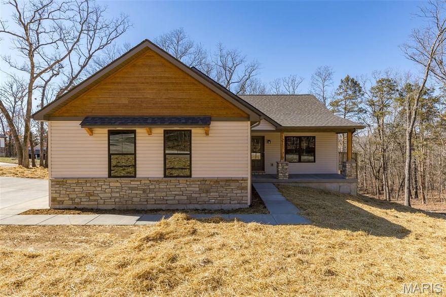 ~ BRAND NEW home in Terre du Lac offers 3 bedrooms, 2 full bathrooms, 2 car side-entry garage & covered front porch. Exterior stone accents are also found inside! Floor to ceiling stone surrounds the electric fireplace complete with hearth and mantle. Vaulted ceilings and open floor plan with 100% waterproof hybrid resilient plank flooring throughout. 5" solid wood base trim. Dark bronze tilt-in windows. Kitchen features soft close oak cabinets with hardware & quartz countertops, a center island, crown molding, all four GE stainless appliances, backsplash, garbage disposal & walk-in pantry with custom shelving & cabinets with countertop. Primary bedroom features a walk-in closet & full bath with Onyx step-in shower and glass shower door enclosure. The spacious main floor laundry just off the attached garage is complete with mud sink & shelving. Deck overlooks wooded view. Walkout basement is a blank canvas with rough-in plumbing for future bath, egress windows & upgrade feature of an 8'x19' concrete vault room with electric and door. Spectrum available. Builder provides a one-year warranty. All measurements are approximate. Private lake community 1 hour south of STL. 16 lakes, fish, boat, swim.