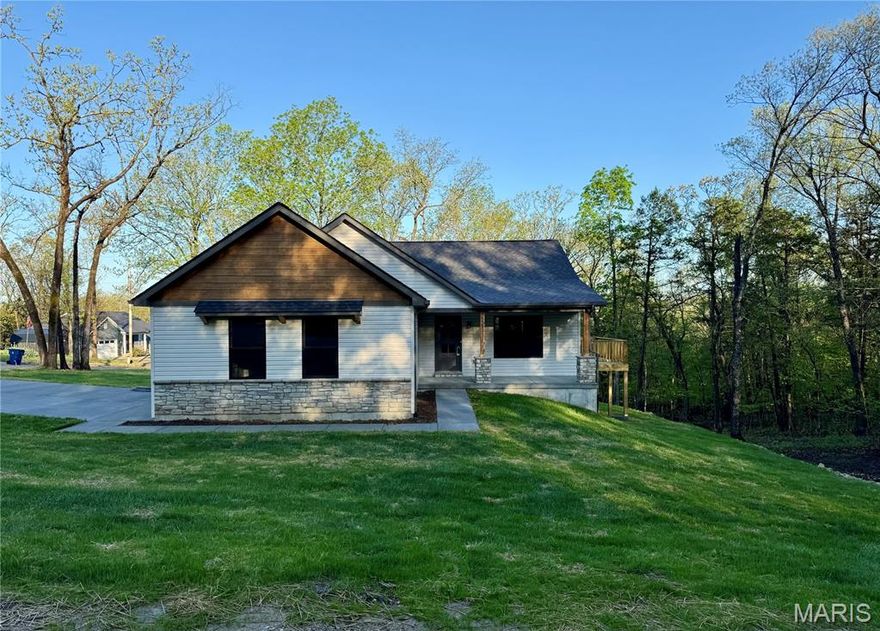 ~ BRAND NEW home in Terre du Lac offers 3 bedrooms, 2 full bathrooms, 2 car side-entry garage & covered front porch. Exterior stone accents are also found inside! Floor to ceiling stone surrounds the electric fireplace complete with hearth and mantle. Vaulted ceilings and open floor plan with 100% waterproof hybrid resilient plank flooring throughout. 5" solid wood base trim. Dark bronze tilt-in windows. Kitchen features soft close oak cabinets with hardware & quartz countertops, a center island, crown molding, all four GE stainless appliances, backsplash, garbage disposal & walk-in pantry with custom shelving & cabinets with countertop. Primary bedroom features a walk-in closet & full bath with Onyx step-in shower and glass shower door enclosure. The spacious main floor laundry just off the attached garage is complete with mud sink & shelving. Deck overlooks wooded view. Walkout basement is a blank canvas with rough-in plumbing for future bath, egress windows & upgrade feature of an 8'x19' concrete vault room with electric and door. Spectrum available. Builder provides a one-year warranty. All measurements are approximate. Private lake community 1 hour south of STL. 16 lakes, fish, boat, swim.