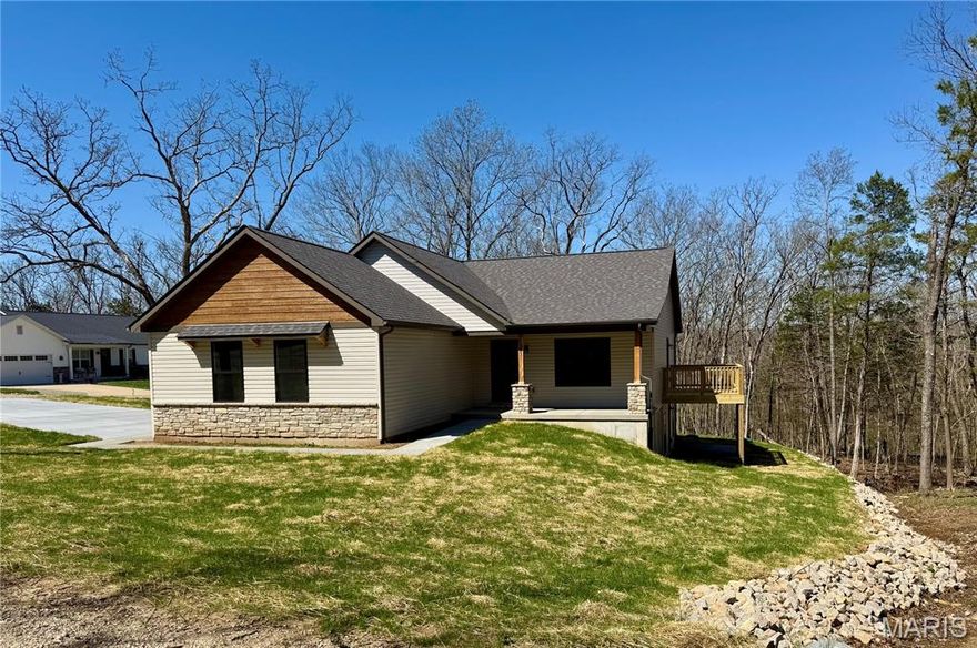 ~ BRAND NEW home in Terre du Lac offers 3 bedrooms, 2 full bathrooms, 2 car side-entry garage & covered front porch. Exterior stone accents are also found inside! Floor to ceiling stone surrounds the electric fireplace complete with hearth and mantle. Vaulted ceilings and open floor plan with 100% waterproof hybrid resilient plank flooring throughout. 5" solid wood base trim. Dark bronze tilt-in windows. Kitchen features soft close oak cabinets with hardware & quartz countertops, a center island, crown molding, all four GE stainless appliances, backsplash, garbage disposal & walk-in pantry with custom shelving & cabinets with countertop. Primary bedroom features a walk-in closet & full bath with Onyx step-in shower and glass shower door enclosure. The spacious main floor laundry just off the attached garage is complete with mud sink & shelving. Deck overlooks wooded view. Walkout basement is a blank canvas with rough-in plumbing for future bath, egress windows & upgrade feature of an 8'x19' concrete vault room with electric and door. Spectrum available. Builder provides a one-year warranty. All measurements are approximate. Private lake community 1 hour south of STL. 16 lakes, fish, boat, swim.