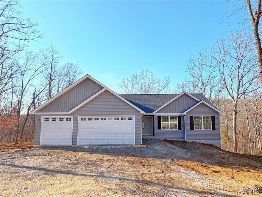 Beautiful new home situated on 3.3 acres! This 1,595 sq. ft. ranch backs to wooded privacy and offers a wonderful view of the surrounding forest from the covered rear deck. Inside, you’ll find luxury vinyl plank flooring throughout, a 12-foot vaulted ceiling in the living room, and beautifully tiled ceramic showers. The home also includes a 3-car attached garage, main-floor laundry, and a walk-out basement with plumbing rough-in ready for future expansion. The kitchen/dining combo shines with granite countertops, canned lighting, shaker soft close cabinets and stainless-steel Whirlpool appliances & sliding door to back deck overlooking the hills for the perfect fall views & spacious backyard. The primary en-suite boasts a separate tiled shower & soaking tub with plenty of natural lighting. Schedule to tour it today!