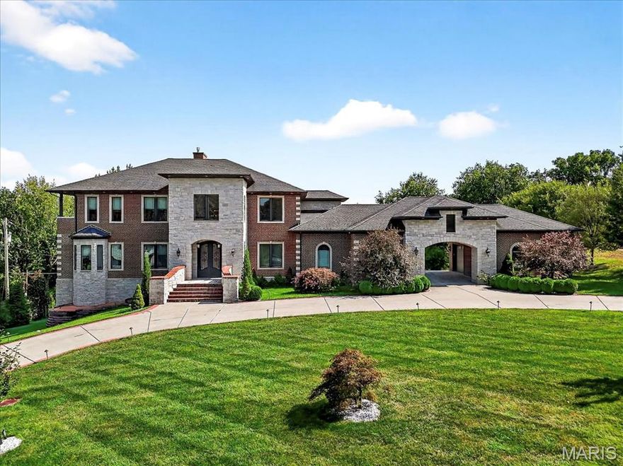 Set on a beautifully landscaped one acre lot in the sought after Thornhill Estates, this magnificent seven bedroom, eight and a half bath residence offers nearly ten thousand square feet of refined living. Built in 2017, the home combines modern comfort with timeless design and meticulous craftsmanship. Every detail, from the imported marble flooring and custom medallions to the handcrafted furnishings tailored specifically for this residence, reflects an uncompromising commitment to quality.

A roundabout driveway leads to the elegant entry and a four car garage with two covered carports. Inside, the foyer opens to soaring ceilings on the main level, introducing an atmosphere of grandeur that continues throughout. Imported marble flooring with matching trim, intricate ceiling designs, and imported chandeliers establish a tone of elegance from the first step.

The great room serves as the heart of the main level, anchored by tall ceilings and expansive windows that fill the space with natural light. From here, doors open to a grand wood deck overlooking the pool and manicured grounds, creating a seamless connection between indoor and outdoor living.

The gourmet kitchen was designed for both entertaining and daily enjoyment. It features three tiered velvet edged marble countertops, custom cabinetry, and top of the line appliances. The generous island and breakfast area make this space both practical and beautiful. Just beyond the kitchen, a hearth room with its own medallion ceiling and chandelier offers a warm and inviting setting for relaxed gatherings. Across the hall, the formal dining room mirrors that same attention to detail, highlighted by its own medallion centerpiece and chandelier, creating an elegant space for memorable dinners.

Also on the main floor is a private office or den, perfect for use as a secondary living room, study, or library.

The main floor master suite is a peaceful retreat, offering a spa inspired bathroom with dual vanities, soaking tub, and walk in shower. A spacious custom closet provides ample storage, while a large bay window captures breathtaking views of the property, filling the suite with light and tranquility. Beyond the master suite, the main floor includes two additional bedrooms, each with its own private bathroom, offering comfort and privacy for family or guests.

Upstairs, the sense of openness continues with a grand loft that overlooks the great room below, creating a striking architectural feature. Two bedrooms on this level include private balconies that offer elevated views of the surrounding landscape. Each bedroom throughout the home includes its own ensuite bath, ensuring every resident enjoys the same level of comfort. A convenient laundry room on this floor complements the additional laundry on the main level.

The lower level extends the home’s versatility with a full secondary kitchen, a large living room centered around a stunning onyx fireplace, and a state of the art theatre room for an immersive entertainment experience. A dedicated gym area provides space for personal fitness, while two adjoining rooms are ready to be finished as a steam room and sauna, allowing the next owner to create a complete spa environment.

For effortless poolside living, a separate pool storage and cleaning area includes a full bathroom, providing convenience for guests before reentering the home. The resort style pool is surrounded by generous patios perfect for outdoor dining, lounging, or entertaining. Mature landscaping ensures privacy and natural beauty year round.

Every element of this home reflects thoughtful design and enduring craftsmanship. From the marble floors and medallioned ceilings to the custom furnishings and resort style amenities, this residence is a statement of luxury and comfort. With its commanding presence and one of the most desirable addresses in the area, this Thornhill Estates estate represents refined living at its finest.