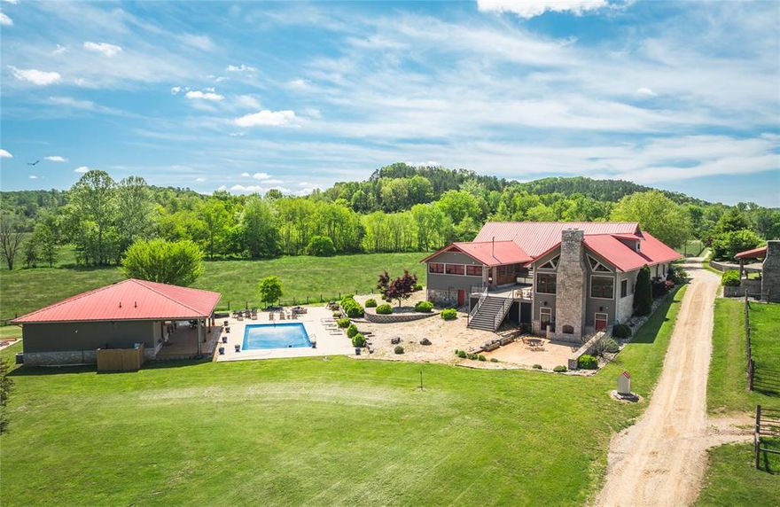 Welcome to Logan Creek Ranch! This amazing property consists of 102 +/- acres in the heart of the Ozarks. The main house features 4 bedrooms/ 4.5 bathrooms, open floor plan with great entertainment spaces, bar, 2 laundry rms, gym and utility area. Relax outside on the new porch w/outdoor kitchen/BBQ or enjoy the 20’x40’ inground pool. Guests will enjoy the pool house w/ 2 beds/2 baths and bar. Additionally on the grounds there is a heated bunkhouse for 12, camper hookups, multiple outbuildings including the main shop with electric and concrete. This ranch is setup perfect for livestock with roughly 60 acres of fenced/cross fenced pasture, 3 ponds and remainder in mature timber. You need to see this one to truley appreciate the details and take in the beauty of this ranch. Give me a call today for your private showing.