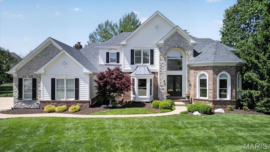 Step in to this exceptional 4BR/4.5BA 1.5 Story Home, perfectly situated on over half an acre level lot at the end of a quiet cul de sac. The professionally landscaped grounds, complete with accent lighting, set the tone for this stunning property, while the three car side entry garage and striking stone and brick elevation create unforgettable curb appeal.  A grand double door entry welcomes you inside to the impressive foyer, with soaring ceilings and dramatic T-staircase complimented by triple crown molding and beautifully arched cased openings leading to the Formal Dining Room and private Executive Office.   The Dining Room features wood flooring, a bay window, chandelier, chair rail and direct access to the Butler’s Pantry and Kitchen, perfect for seamless entertaining.  The Executive Office is a showpiece, highlighted by an architectural beamed ceiling, wainscoting, wood floors, recessed lighting, and three floor-to-ceiling arched windows that flood the space with natural light.  The Great Room is spacious and inviting, offering a wall of atrium windows overlooking the back yard, gas fireplace, ceiling fans, in ceiling speakers and exquisite triple crown molding.  The updated Kitchen has custom cabinetry, soft-close drawers, granite countertops, tile backspash and premium stainless steel appliances, including a Thermador five burner gas range with hood and a Bosch double wall oven.  A two-tiered center island offers ample seating, while the walk-in pantry and large sink with picture window enhance functionality.  The Kitchen flows into the Breakfast Room and Vaulted Hearth Room, featuring a brick gas fireplace and wall of transom-topped windows overlooking the back yard oasis.  The main floor Primary Suite is a serene retreat, with crown molding, ceiling fan and two walk in closets. An En Suite Primary Bath has been fully remodeled and delivers a spa like experience, with heated tile floors, oversized walk in shower with seating and multiple Grohe showerheads, a free standing soaking tub, custom cabinetry, quartz topped comfort height vanities, and a TOTO bidet commode for ultimate comfort.  Upstairs are three generously sized bedrooms-one with a private en suite bath, and two connected by a Jack and Jill bath- all with walk in closets.  The Finished Lower Level adds more living space with LVP flooring, large Family/Recreation Room, walk behind bar, exercise room, full bath and abundant storage space.  Outside, the resort style back yard is an entertainers dream. Exit to a covered patio with a vaulted wood ceiling, recessed lighting and fan, to a stunning Gunite Pool with waterfall and expansive fenced green space. Exterior speakers complete the perfect setting for gatherings and relaxation. Additional highlights include a level and usable back yard, new roof (April 2026), zoned heating and cooling, 75 gallon water heater, and full irrigation system, ensuring comfort, efficiency and peace of mind.  This home blends timeless elegance with modern upgrades and exceptional indoor/outdoor living - truly a rare opportunity!