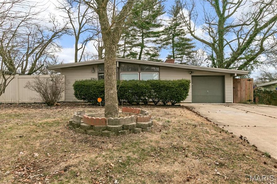 This home in the Robinwood subdivision features an open-concept interior highlighted by vaulted ceilings and a classic brick fireplace. The layout includes a primary bedroom with an en-suite bathroom and well-proportioned secondary rooms. A versatile bonus space is located off the garage, providing additional square footage for a variety of uses. Outside, the property offers a level, fenced backyard equipped with a private deck and a storage shed. The residence is situated in a convenient Florissant location.