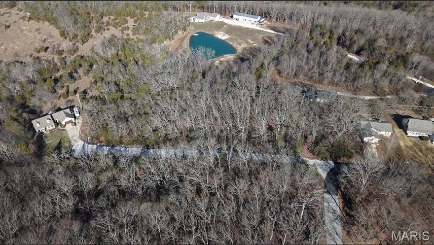 Buy as an individual lot for lake access or check out the neighboring lot to call your very own and save, save, save! These ready-to-build home sites are located in this private, gated, resort-style community with 3 lakes, golf course, campgrounds and more. Perfect for a single builder to market to empty nesters from St. Louis area seeking a peaceful, recreational lifestyle away from St. Louis, but still very close for easy family visits. Also perfect for "get-away" lake home. Enjoy the golf course, lake, boating, fishing, clubhouse, pool, etc. ! Just 20 minutes from South County!