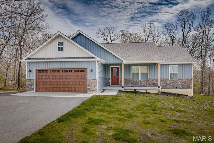 If you’ve been holding out for a house that actually makes sense and doesn’t come with a list of “projects” from the previous owner’s 2003 phase, this might be the one. Built in 2025, you’re getting newer construction without the guesswork, the patch jobs, or the mystery stains.

This 3 bedroom, 2 bathroom home keeps everything on one level so you can skip the daily cardio of running up and down stairs for no reason. The layout is thoughtfully split, with the primary suite on one side and the other two bedrooms on the opposite end. Translation, you get privacy without having to relocate to a different wing of the house.

The primary bedroom adds a little personality with coffered ceilings, along with a walk-in closet that can actually handle your wardrobe. The attached bathroom features a double vanity, which means no more negotiating for sink space every morning.

The kitchen is open to the main living area and centers around an island with granite countertops. It is perfect for cooking, hosting, or just spreading out takeout like you meant to cook. The overall flow feels intentional, which is more than can be said for a lot of homes.

You’ll also find a dedicated laundry room, because hiding appliances in a hallway closet was never the dream. The attached garage makes day-to-day life easier and keeps you out of the weather when it matters.

Step outside and you’ve got a covered front porch that feels like it belongs in a magazine, plus a back deck that gives you outdoor space without signing you up for constant upkeep.

And then there’s Terre du Lac. Living here means access to lakes, a beach, tennis courts, a clubhouse, and even a golf course. So yes, your neighborhood suddenly has more amenities than most vacations. Whether you’re actually using them every weekend or just like knowing they’re there, it’s a pretty solid upgrade.

Brand new, well laid out, and located in a community people actively want to be in. Hard to argue with that.