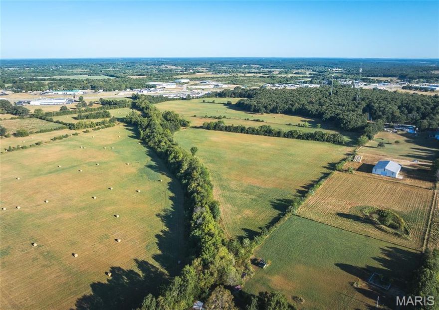 Approx. 20 acres of open pasture with some wooded located just outside the Lebanon city limits. Features75x100 outbuilding has partial concrete and upstairs apartment and bathroom, paved road frontage and access to electric with water located down the road, making it ideal for commercial or residential development.