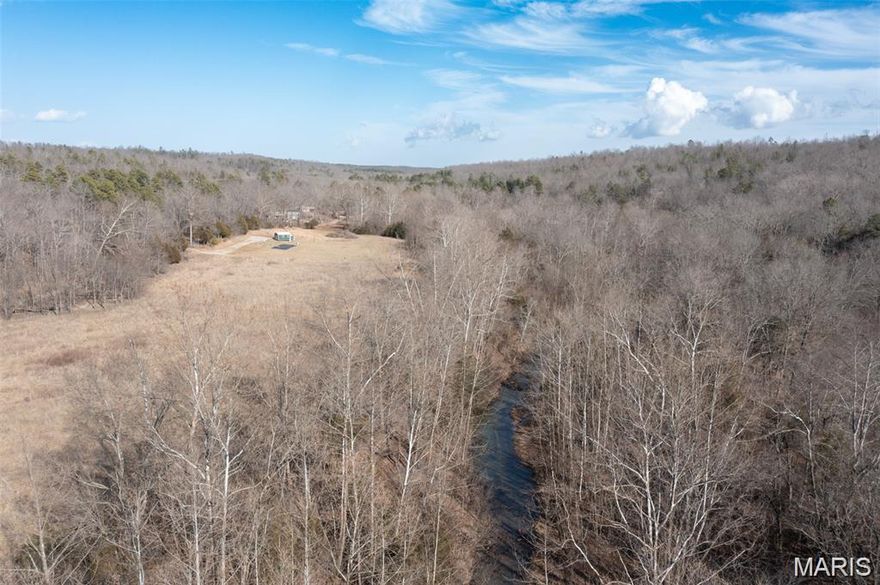 CAPE CREEK ESCAPE :  15.58 surveyed acres, 14x20 one room cabin, orchard/garden, spring fed creek, approximately 4 acres cleared, balance in mixed variety growth of old field and hardwoods. Seller reports many maple trees on the property they have harvested sap from for maple syrup. Trails through out the property, water line installed from creek to water the garden and orchard and electric easement secured and ready to install power. Located just east of Fredericktown, less than 1/4 mile from Castor River and Amidon Memorial Conservation area. This property is perfect for a weekend getaway or to build your dream home in the country.