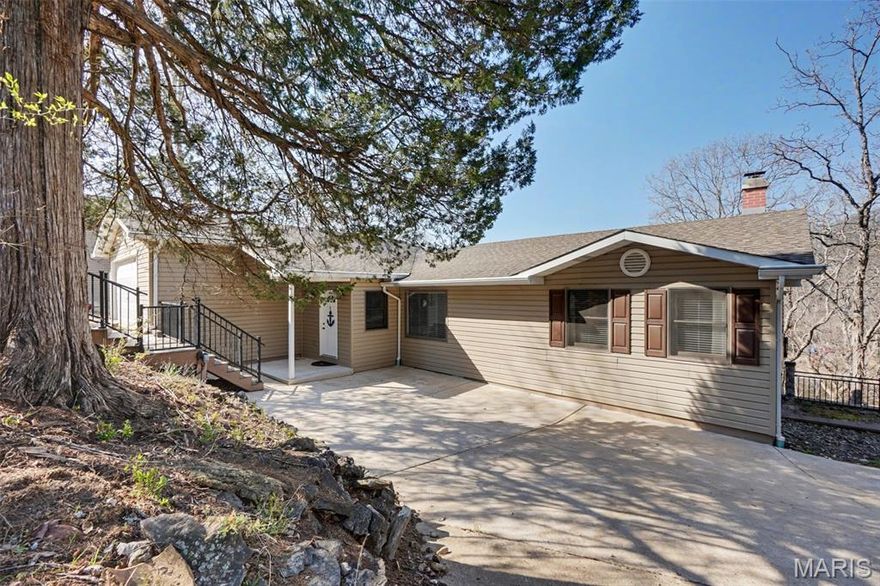 Lakefront living, thoughtfully designed. This updated 3-bedroom, 3-bath ranch sits on the main lake with 120 feet of shoreline, offering expansive views and a layout that balances comfort with functionality. The main level features approximately 1,700 sq ft with a split-bedroom floor plan for added privacy. The primary suite includes a walk-in closet and an ensuite bath with double  bowl vanity, shower, and private water closet. Open living spaces create an easy flow for both everyday living and entertaining, while main floor laundry and an attached 2-car garage add convenience. Two driveways provide additional parking. The finished walk-out lower level offers approximately 1,120 sq ft of additional living space, including a spacious rec room with wood-burning fireplace, plus a separate sleeping area and full bath for added flexibility. Outdoor spaces are designed to make the most of the setting, with a full-length screened-in composite deck overlooking the water, a fenced patio area for gatherings, and a path leading to a private dock and cabana. Located in a gated community with access to multiple lakes, boating, beach areas, camping, and a clubhouse with pool. Conveniently situated approximately 15 minutes from Washington and 20 minutes from Wentzville. A well-rounded waterfront property offering space, access, and year-round enjoyment. Come love and play Lake Sherwood!!