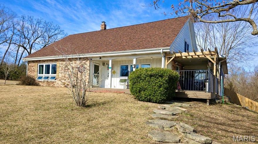 Charming 3 bedroom, 2 bathroom brick and cedar home tucked back off the road on 4 acres m/l, this home offers the perfect balance of country living and accessibility. Newer roof, updated windows, new whole house generator offer peace of mind. From the covered front porch you enter to a large living room to the left framed with picture windows for gorgeous natural right, a family room to the right with a cozy fireplace connected to a lovely country kitchen. Formal dining room spacious enough for entertaining, large master suite with walk-in closet and en-suite bath, and large utility room completes the main level. Upstairs you will find 2 oversized bedrooms with large walk-in closets connected by a jack & jill bathroom and floored attic space for storage. A full unfinished basement offers flexible space. Outside is a brick 3 car detached garage, and a chain-link fenced backyard for convenience. Plenty of outdoor living space with a new composite decking and a sunroom to enjoy your morning coffee.