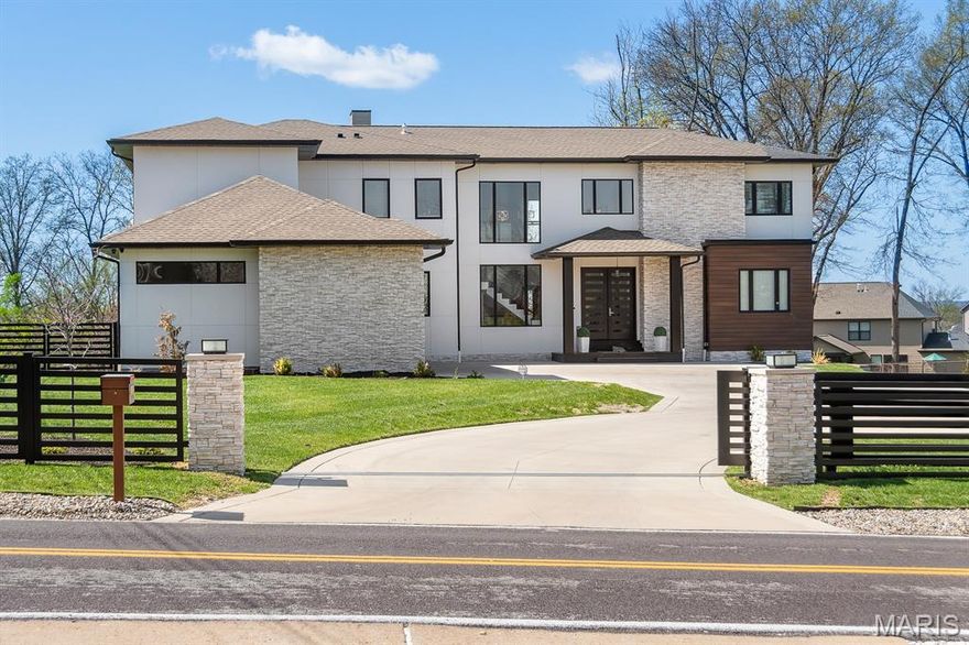 Stunning 7 bed, 6.5 bath custom-built 2023 estate on over an acre. Striking curb appeal with granite front porch and modern design. Step through custom double doors into a bright, open layout featuring soaring ceilings, hardwood floors, glass railings, and intricate millwork. Chef’s kitchen boasts 48” pro range, 12’ waterfall island, quartz tops & backsplash, custom glass cabinetry,microwave drawer, bev center, built-in fridge, and sleek design. Dual primary suites—one on each level—include spa-like baths with freestanding tub and walk-in showers. Upstairs offers 4 beds, 4 full baths, and 2nd laundry. Finished lower level with rec room, wet bar, sauna, and bed/bath. No detail overlooked: 2 high-efficient HVAC's, 2x6 construction, camera system, spray foam insulation, 400 amp service, covered deck/patio, heavy glass & custom tile work in baths, oversized 3-car garage, and custom built fencing w/ dual auto gates.Exceptional blend of luxury, style, and function—truly one of a kind!
