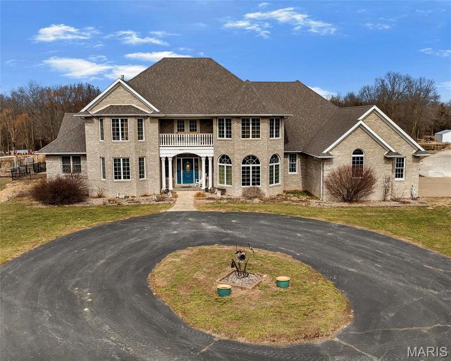 Stunning 11-acre estate offering 4 beds, 4.5 baths, 5,731 finished sq ft and exceptional indoor/outdoor living. Main level features a formal living and dining room, vaulted living room with fireplace, sitting room with 2nd fireplace, office, and sunroom. Primary suite includes hardwood floors, crown molding, patio access, Jacuzzi tub, full shower, double vanity and walk-in closet. Upper level offers 3 bedrooms, hall bath, large foyer with balcony, and a 2nd primary suite with rear balcony. Walkout basement includes a spacious rec room, full wet bar, storm room and 2199 unfinished sq ft large storage areas. Outside features an in-ground saltwater pool with slide, diving board and pool house, a .50-acre stocked pond, walking trails and covered bridge. Includes a 30×60 shop with epoxy floors, 2-post lift, 3 bays, 200-amp service and attached 30×40 pavilion, plus a 24×24 barn. Central vac, 3 HVAC systems, 3 water heaters, fenced playground and beautiful landscaping complete this rare property.With over 7900 total Sq ft.