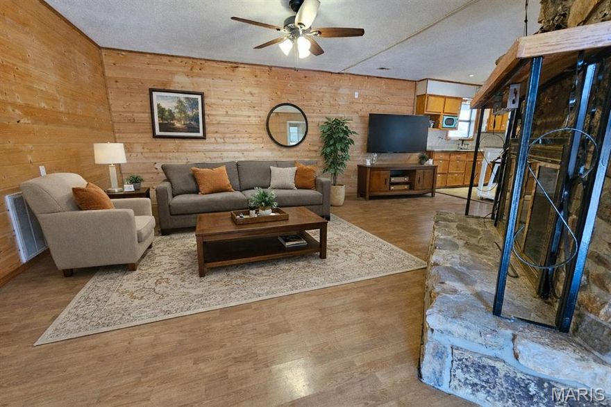 Seller IS MOTIVATED--Priced below appraisal----SOLD AS IS---Located just off Main Street, not in a flood zone, in Van Buren, Mo secluded behind a tree line you will find this adorable home.  This 3 bedroom,  1 1/2 bath home has an open concept living room/kitchen.  There is a beautiful stone wood burning fireplace located in the living room.  There are 3 bedroom and a separate dining room.  The yard is filled with beautiful hostas that are beginning to sprout upward.  There is a drive-thru asphalt drive and a single car carport.  If this isn't enough there is a 16 x 24 workshop with an 8 x 20 lean to perfect to store your boat after a day on the Current River.  The shed has electric and a window air unit, and is set up for a heat stove also.  Plenty of room for a workshop, or a he shed. The amenities or fine dining and shopping in Van Buren  are within moments from this home as well as the public boat ramp and beach.  Call today and schedule your private viewing.