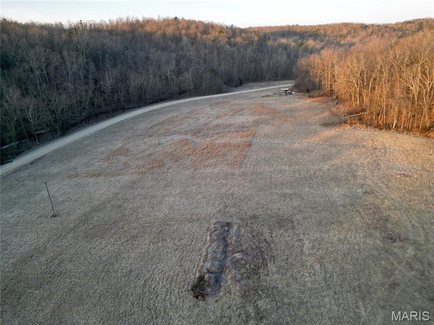 Discover the perfect blend of open space and natural beauty with this stunning 17± acre property offering a mix of open fields and mature woods. Gently rolling hills create a picturesque landscape and provide breathtaking views. Outdoor enthusiasts will appreciate the ATV riding trails that wind through the wooded areas, making this property ideal for recreation, hunting, or simply exploring your own private retreat. The partially fenced acreage offers flexibility for livestock, horses, or future improvements. There are two small sheds near the county road frontage equipped with wind and solar power. BREC electric service runs across the property, adding convenience and potential for future building plans. Whether you’re looking to build your dream home, create a weekend getaway, or invest in versatile land with both beauty and functionality, this property offers endless possibilities in a peaceful, scenic setting. Property lines are approximate and subject to survey.