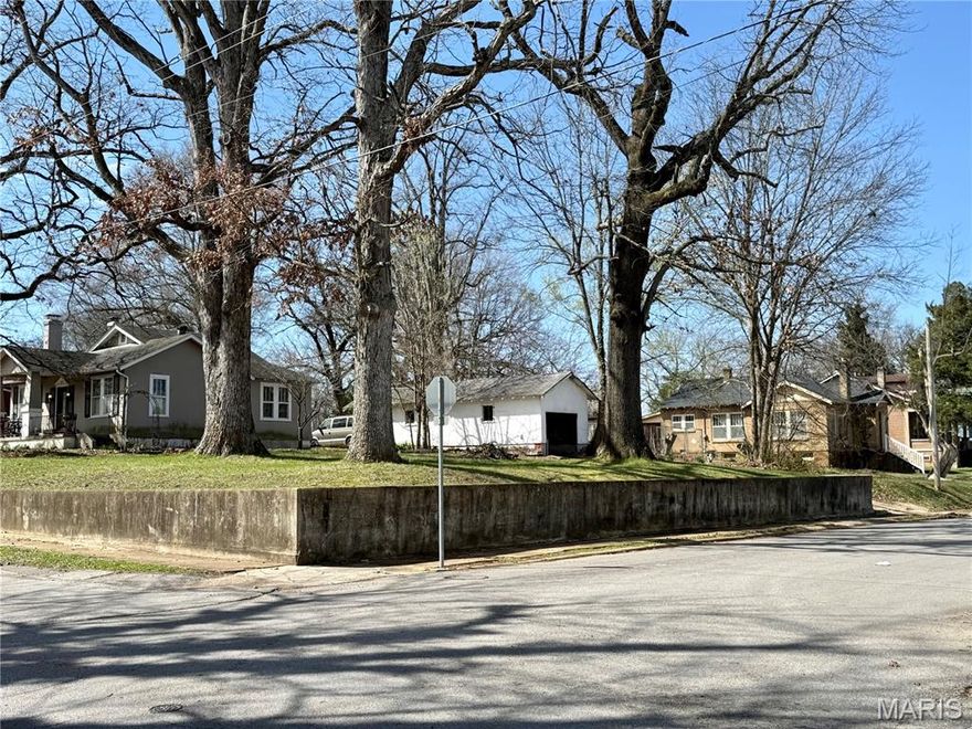 Imagine building your dream home on a piece of Poplar Bluff history, where the charm of the past meets the potential of the future. This unique infill lot at 645 N 9th Street sits prominently at the corner of 9th and Maud Street, elevated above the road by a classic concrete terraced wall that provides both character and a sense of charm. As a former homesite, the land is perfectly primed for a new, small-scale construction project, offering the rare advantage of established infrastructure like a ready-to-use driveway and attached covered parking.

The location feels like a hidden gem within a mature community, situated just off the iconic brick-paved stretch of Main Street and only a short distance from the energy of downtown. You’ll enjoy the convenience of having Ferguson Grove Park as your immediate neighbor, extending your living space into wide open green views and recreational paths.

Life here is designed for walking, with existing sidewalks wrapping around two sides of the property and several mature shade trees already standing tall to provide a natural canopy for your future front porch. By choosing this "fill-in" property, you aren't just buying a lot; you are becoming part of an established neighborhood fabric while benefiting from modern building possibilities and nearby public utilities.
