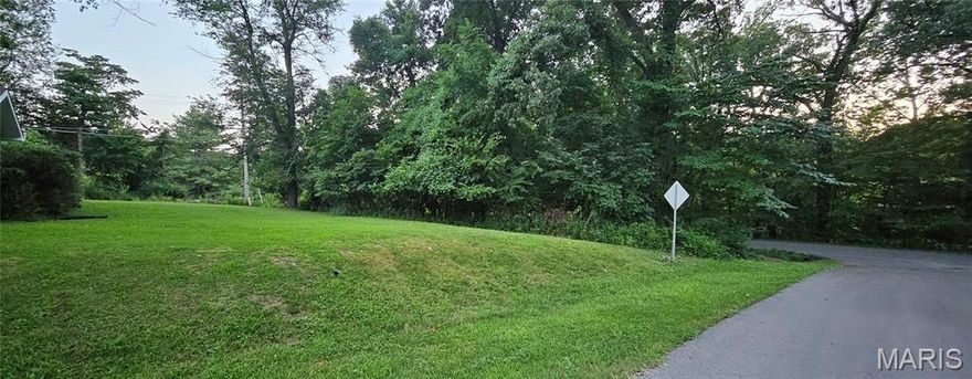 Large partially wooded corner lot in established Cape Girardeau neighborhood.
