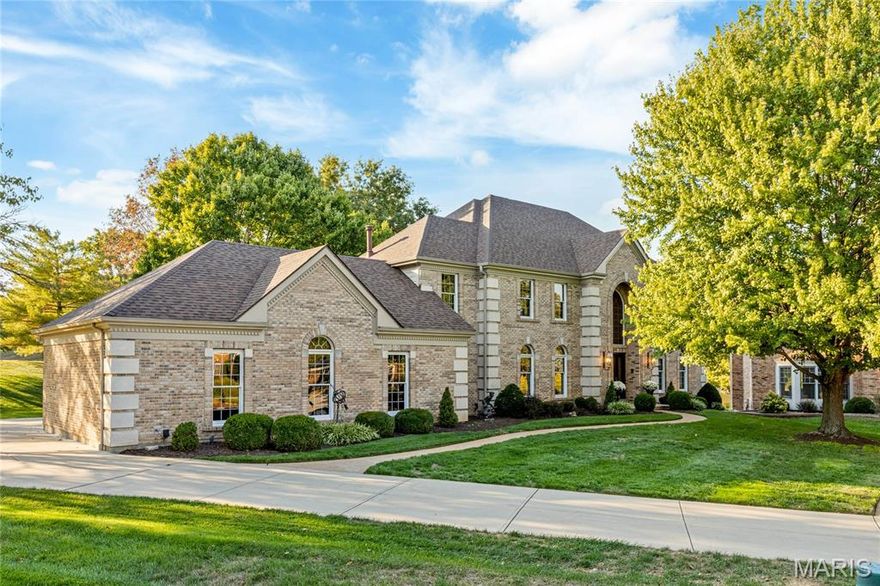 Classic-styled brick & stone 2 Sty in prestigious Manors of Town & Country. This Taylor Morley Simon-built home features a well-designed floor plan with marble flooring, detailed trim work & palladian windows. Enter the 2-sty marble foyer that leads to formal living room, dining room with tray ceiling & spectacular family room with marble fireplace, wet bar, wide bay window & atrium door that opens to patio that overlooks pond & common ground. Chef’s kitchen with white cabinetry, granite countertops, stainless steel appliances & 6’ center island adjoins light-filled breakfast room with convenient planning center & vaulted sunroom. T-staircase accesses coffered primary bedroom suite with luxury bath with jetted tub plus 3 additional bedrooms, 1 with ensuite bath & 2 with Jack n’ Jill bath. Lower Level entertainment space includes recreation room with fireplace & wet bar, game room, hobby room, office & full bath.  Situated on a .5-acre cul-de-sac lot with patio & oversized 3-car garage.